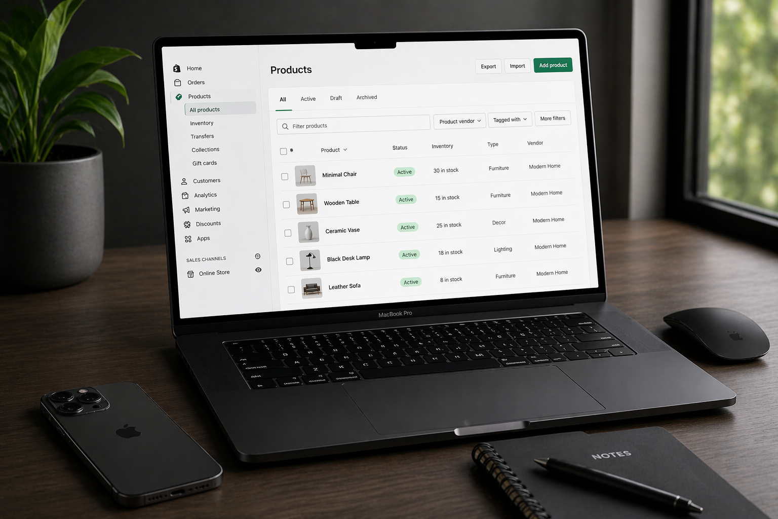 macbook pro with iphone and magic mouse displaying shopify product listing page